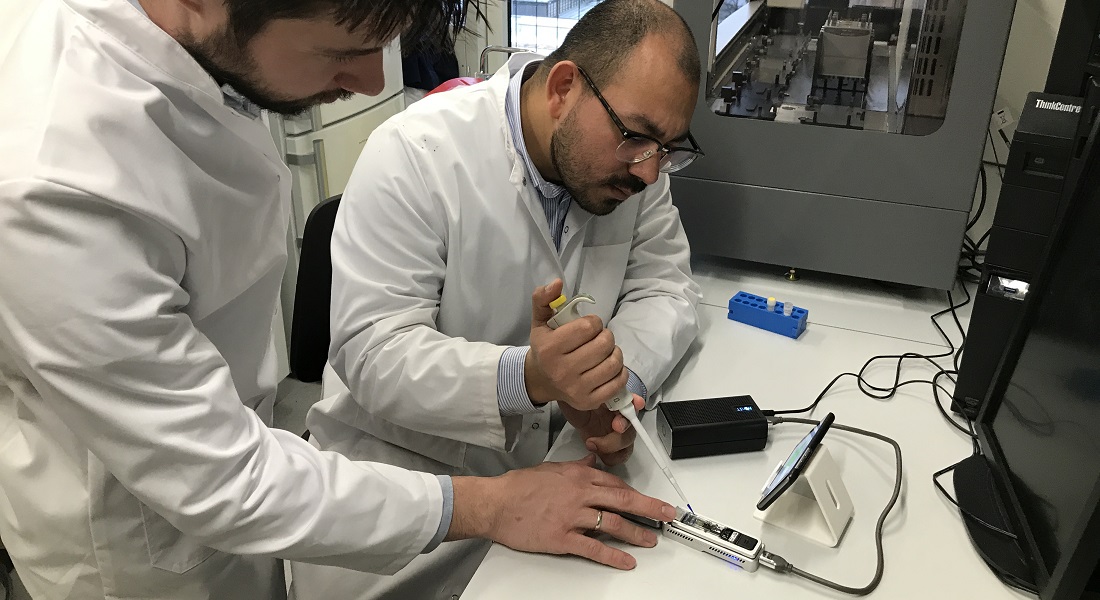 Lukasz Krych and Josue L. Castro Mejia from the Department of Food Science are loading the small device with DNA material.