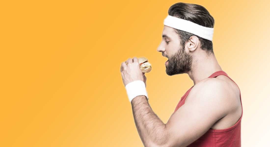Foto af en atlet, der spiser en burger
