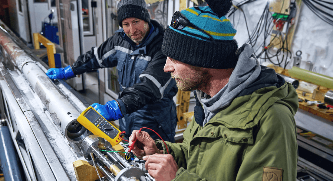 Ice core scientists adjusting the ice drill