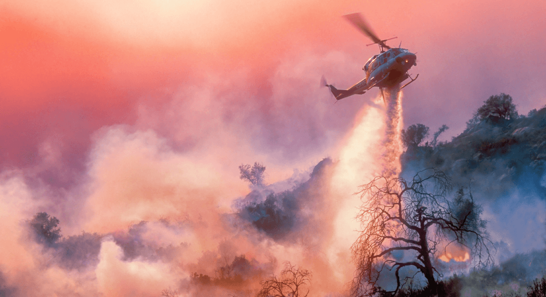 Helicopter is dumping water on the fires in California