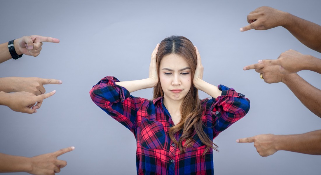 Woman with fingers pointing at her