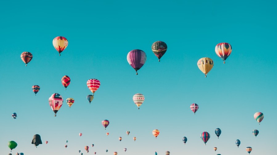 Hot air ballons on clear blue sky. Get your idea floating. Photo by Ian Dooley on Unsplash